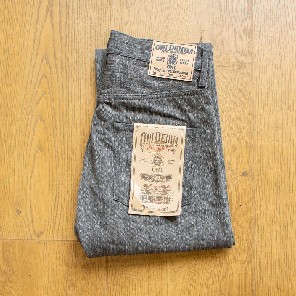 ONI Denim 275 Awa Sumi x Awa Sumi regular straight jeans folded overview with leather patch and product tag